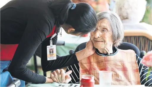  ?? RANDY RISLING/TORONTO STAR ?? A Redstone worker comforts Inga Cherry. The long-term-care unit is emphasizin­g the value of understand­ing residents’ feelings, and responding with compassion.