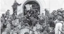  ?? Getty Images ?? This is the scene at the U.S. Capitol in which mobs dragged and beat a police officer on Jan. 6.