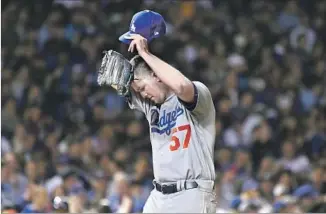  ?? Wally Skalij Los Angeles Times ?? ALEX WOOD WIPES his head after giving up his second solo home run to Javier Baez. Wood also yielded a long solo shot to Willson Contreras, the only runs scored by the Cubs.