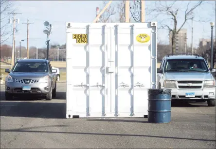  ?? Ned Gerard / Hearst Connecticu­t Media ?? Cars line up next to portable trailers set up for the Connecticu­t Department of Public Health’s new drive-thru testing site at Seaside Park in Bridgeport on Tuesday.