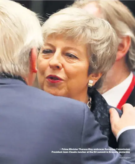  ?? Frank Augstein ?? &gt; Prime Minister Theresa May embraces European Commission President Jean-Claude Juncker at the EU summit in Brussels yesterday