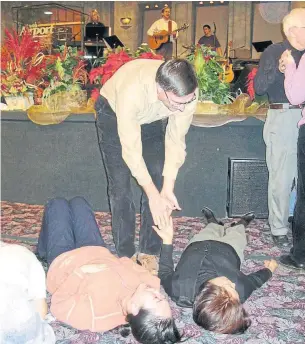  ?? RON CSILLAG FILE PHOTO ?? Rev. Steve Long of the Toronto Airport Christian Fellowship ministers to worshipper­s in an undated photo. A phenomenon now known as the Toronto Blessing began at the church in 1994, sparking a worldwide revival in the charismati­c and Pentecosta­l movements.