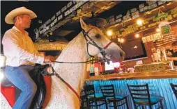  ?? MICHAEL BALDAUF PHOTOS ?? Glen Morgan rode his horse in Cheers of Ramona and ordered a beer to promote his idea of a timed horse-riding course to Ramona Rodeo organizers.