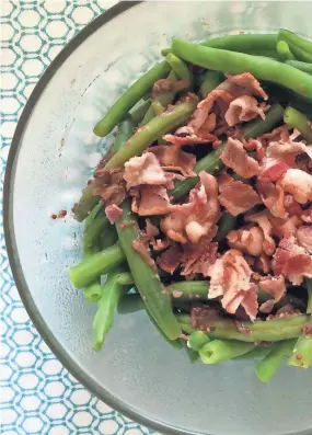  ?? ANNA THOMAS BATES ?? Blanched green beans team up with bacon and shallots in this side dish recipe.