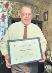  ?? (Pic: Marian Roche) ?? Paki pictured at home with his certificat­e in recognitio­n of 60 years service in the forecourt in Mitchelsto­wn.