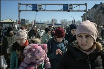  ?? MAURICIO LIMA — THE NEW YORK TIMES ?? People fleeing the fighting in Ukraine wait for buses after crossing the border into Palanca, Moldova, on March 15. The effort to support Ukrainian refugees may cost government­s as much as $30billion in the first year.