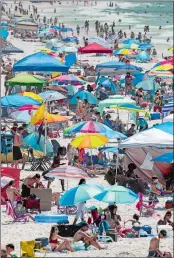  ?? DAVID GRUNFELD/THE ADVOCATE VIA AP ?? People visit Pensacola Beach in Pensacola, Fla., Saturday during the coronaviru­s pandemic.