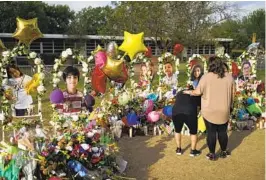  ?? ?? Jolean Olvedo (left) is comforted by her partner, Natalia Gutierrez, at a memorial for the students and teachers who were killed the shooting in Uvalde, Texas.