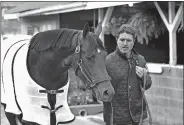  ?? GARRY JONES/AP PHOTO ?? Trainer Keith Desormeaux walks his Kentucky Derby hopeful, Exaggerato­r out for a bath following his gallop on Tuesday at Churchill Downs in Louisville, Ky. The 142nd Kentucky Derby is Saturday.