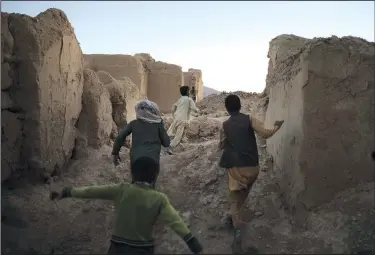  ?? (AP/Felipe Dana) ?? Afghan children play Oct. 12 among the ruins of houses destroyed by war in Salar village, Wardak province, Afghanista­n.