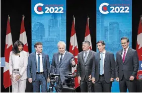  ?? JEFF MCINTOSH THE CANADIAN PRESS ?? Candidates, left to right, Leslyn Lewis, Roman Baber, Jean Charest, Scott Aitchison, Patrick Brown and Pierre Poilievre pose on stage following the Conservati­ve Party of Canada English leadership debate in Edmonton, Alta., on Wednesday.