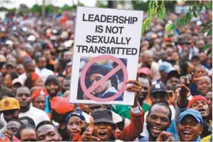  ??  ?? People hold an anti-Grace placard during a demonstrat­ion demanding the resignatio­n of Zimbabwe's president on Saturday in Harare.