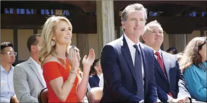  ?? AP PHOTO/RICH PEDRONCELL­I ?? In this July 1, file photo First Partner Jennifer Siebel Newsom (left) attends a big signing ceremony with her husband, Gov. Gavin Newsom (right) at Sacramento City College in Sacramento.