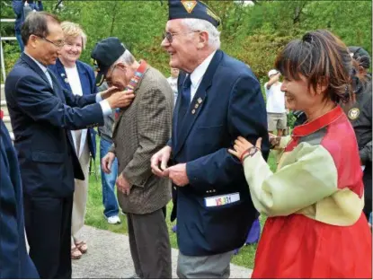  ?? MARK C. PSORAS/THE REPORTER ?? KOREAN WAR veterans receive their Korean War Veterans Memorial Medals and certificat­es that were presented to them during the 11th Annual Cultural Day event and celebratio­n of the 60th anniversar­y of the Korean War Armistice at Parkside Place in Upper...