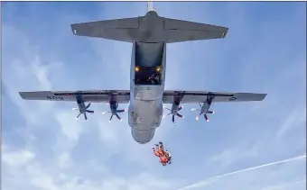  ?? Photos coutesy of Skyhawks Parachute Team ?? Local Journalism Initative photograph­er Mark Brett leaps out of a Hercules aircraft with Master Cpl. Marc Dumaine of the Skyhawks Parachute Team, Tuesday morning.