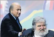  ?? Fabrice Coffrini AFP/Getty Images ?? FIFA PRESIDENT Sepp Blatter, who has agreed to step down, taps the shoulder of former executive committee member Chuck Blazer at a 2011 meeting.