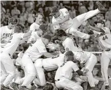  ?? Nati Harnik / Associated Press ?? Florida players fly in from all directions to celebrate beating LSU on Tuesday night to lock up the College World Series title.