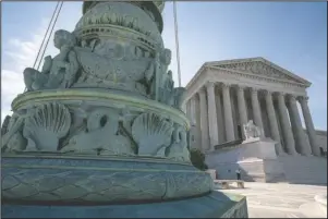  ?? The Associated Press ?? NEW TERM: In this June 17 file photo, The Supreme Court is seen in Washington. Abortion rights, and protection­s for young immigrants and LGBT people top an election-year agenda for the Supreme Court. Its conservati­ve majority will have ample opportunit­y to flex its muscle, testing Chief Justice John Roberts’ attempts to keep the court clear of Washington partisan politics.