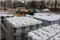  ?? EVAN BRANDT — MEDIANEWS GROUP ?? Firefighte­rs at Goodwill fire station on East High Street provided free cases of bottled water to a steady stream of cars Thursday afternoon.