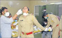  ?? SAKIB ALI/HT ARCHIVE ?? A policewoma­n being tested for Covid-19 at MMG hospital in Ghaziabad.