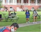  ?? ATLANTA JOURNAL-CONSTITUTI­ON VIA AP FILE ?? Georgia College and State University freshmen Ashlynn Anglin, right, and Meghan Murphy walk on campus.