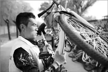  ??  ?? Unloading shared bicycles from a vehicle at a repair centre in Beijing. — AFP photos