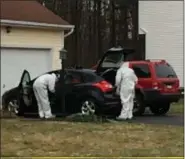  ?? GLENN GRIFFITH PHOTO ?? New York State Police crime scene investigat­ors inspect the contents of two vehicles parked in the driveway of a home at 723Adams Circle, Ballston Spa on Saturday.