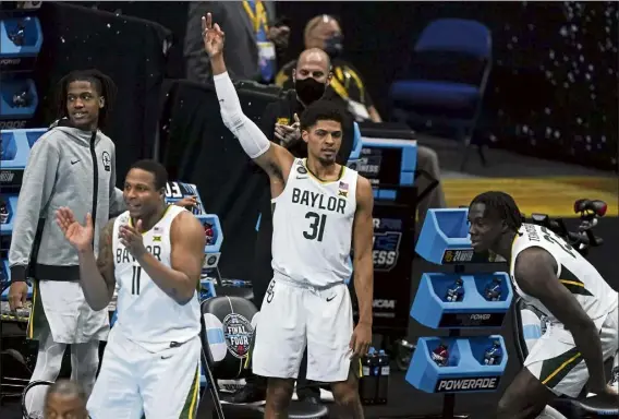  ?? Ap ?? Baylor players celebrate on the bench during the first half of a Final Four game against Houston on Saturday at lucas Oil Stadium in indianapol­is.