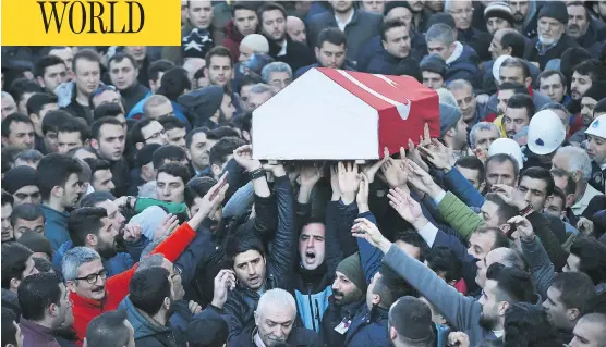  ?? EMRAH GUREL / THE ASSOCIATED PRESS ?? Mourners chant slogans as they carry the Turkish flag-draped coffin of Yunus Gormek, 23, one of the victims of the attack at a nightclub on New Year’s Day, during the funeral in Istanbul, on Monday. Turkey’s state-run news agency says police have...