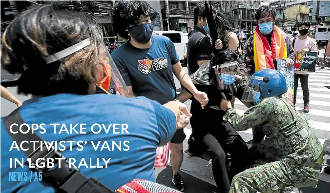  ?? —AFP ?? DISPERSAL Activists celebratin­g LGBT Pride Month with a rally in Manila are rounded up by the police near Malacañang on Friday. Their lawyer later questioned the arrest, especially after officers reportedly commandeer­ed the protesters’ vans after forcing them back into the vehicles.