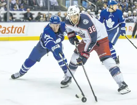  ?? ERNEST DOROSZUK/TORONTO SUN ?? Toronto’s Morgan Rielly defends against Columbus’s Boone Jenner during a 3-2 Maple Leafs loss on Monday in Toronto.