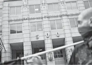  ?? Andrew Harrer / Bloomberg ?? A demonstrat­or protests the detainment and separation of immigrant families in front of the Immigratio­n and Customs Enforcemen­t headquarte­rs in Washington, D.C.