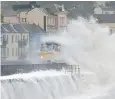  ??  ?? Storm Callum batters the seafront at Dawlish on Devon’s south coast