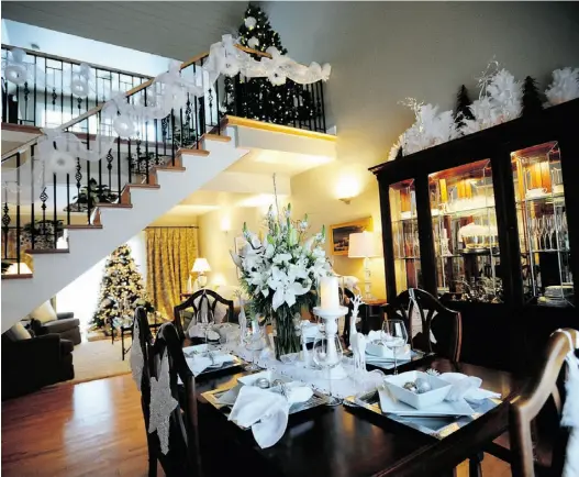  ?? Photos: Bruce Edwards/
Edmonton Journal ?? This Glenora home is decked all in white for the holidays, with plush white stockings, above right, and a flock of white owls in a glass bowl.