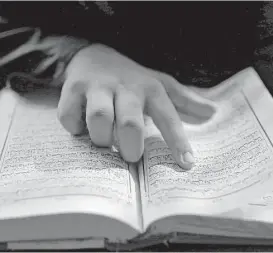  ?? A.M. Ahad / Associated Press ?? A Bangladesh­i Muslim student reads the holy Quran at an Islamic school during Ramadan in Dhaka, Bangladesh. Muslims throughout the world are marking the holy month of Ramadan, during which they fast from dawn till dusk.