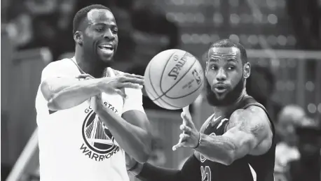  ?? AP Photo ?? Golden State Warriors' Draymond Green, left, passes against Cleveland Cavaliers' LeBron James in the first half of an NBA basketball game, Monday, Jan. 15, 2018, in Cleveland.