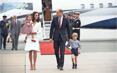  ?? BARTLOMIEJ ZBOROWSKI, AFP/GETTY IMAGES ?? Kate, Duchess of Cambridge, and Prince William will give Prince George and Princess Charlotte a brother or sister in a few months. Kate is said to be having acute morning sickness, prompting Kensington Palace to announce her pregnancy.