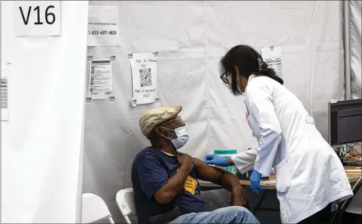  ?? DAVE SANDERS/NEW YORK TIMES ?? A 78-year-old man receives a booster shot in New York last month. Regardless of the evolving understand­ing of natural immunity, on one point there is near-universal agreement among scientists. For people who were never infected, vaccines are much safer, and far less a gamble, than COVID-19.