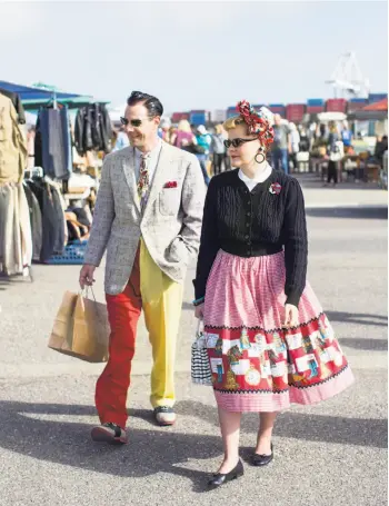  ??  ?? Laurence Brucker, right, and Sylvain Delteil shop at the Alameda Point Antiques Faire while dressed in vintage clothing in April. The couple was visiting from France. They dress in 1950s clothing everyday and document themselves for a blog called “Lost in the 50s.”