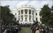  ?? CAROLYN KASTER - THE ASSOCIATED PRESS ?? In this Dec. 20 file photo, President Donald Trump surrounded by members of congress and supporters as he speaks during an event on the South Lawn of the White House in Washington, to acknowledg­e the final passage of tax overhaul legislatio­n by...