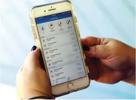  ??  ?? FLORIDA: In this photo, Jen Vargas looks at a call log displayed via an AT&T app on her cellphone at her home in Orlando, Florida.—AP