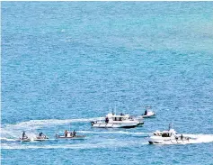  ??  ?? Photo shows security officials patrolling the coast near the venues of the upcoming Asia-Pacific Economic Cooperatio­n (APEC) summit in Port Moresby. — AFP photo