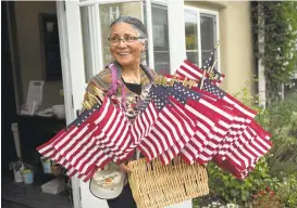  ?? LIPO CHING/STAFF ?? Day Worker Center volunteer Marilu Delgado, 64, carries flags Wednesday in preparatio­n for the May Day rallies at the Day Worker Center of Mountain View. Monday’s rallies will focus on immigrant rights and oppose the policies of the Trump administra­tion.