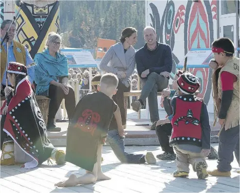  ?? PHOTOS: JONATHAN HAYWARD / THE CANADIAN PRESS ?? Prince William and his wife Kate, the Duke and Duchess of Cambridge, watch native youth dancers perform during a welcoming ceremony in Carcross, Yukon, on Wednesday.