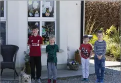  ??  ?? Harry, Marcus, Darragh and Jason Orr with their Easter windows which they decorated as part of a Dunlavin Forum initiative.