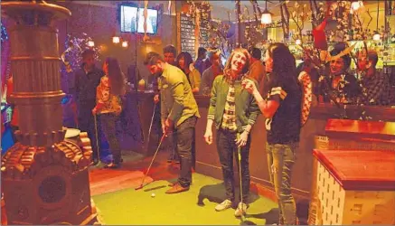  ?? Christophe­r Reynolds
Los Angeles Times ?? URBAN PUTT
in the Mission District is a year- old bar and restaurant that makes room for 14 eccentric holes of mini- golf.