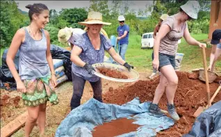  ??  ?? Community dig: Gardeners practise sustainabl­e farming at the ecovillage