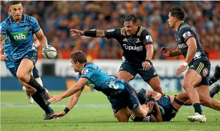  ?? PHOTO: GETTY IMAGES ?? Sonny Bill Williams, left, charges on to the ball for the Blues against the Highlander­s in the first full round of Super Rugby last weekend.
