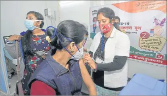  ??  ?? A health-care worker gets vaccinated against Covid-19 at a private hospital in Sector 27, Noida, on Monday.