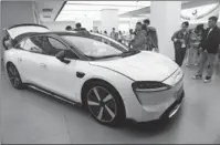  ?? LONG WEI / FOR CHINA DAILY ?? Left: Luxeed S7, an electric sedan developed by Huawei, is on display at the company’s flagship store in Hangzhou, Zhejiang province, in December.